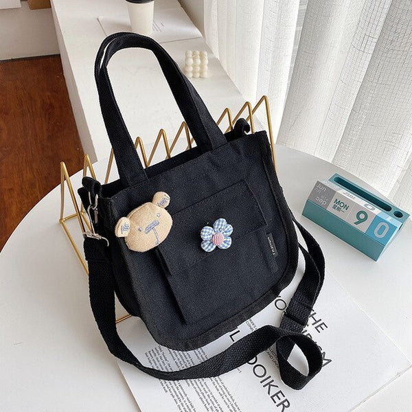 New women's shoulder bag  solid color  double pockets  personalized flower accessories  daily travel student small messenger bag